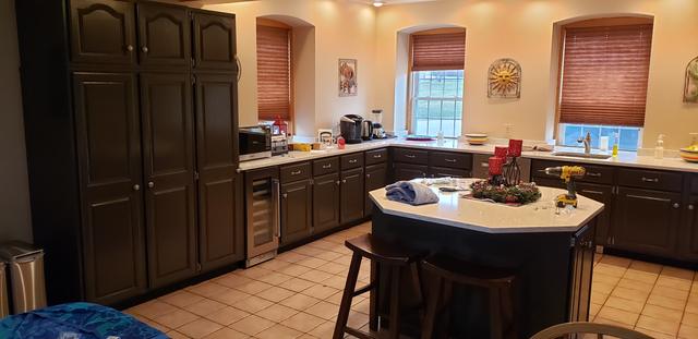 Kitchen cabinets in a deep, dark finish by Jewell Painting