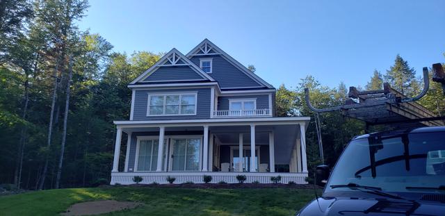 Farmhouse with a wraparound porch by Jewell Painting