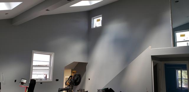 Great room with skylights by Jewell Painting